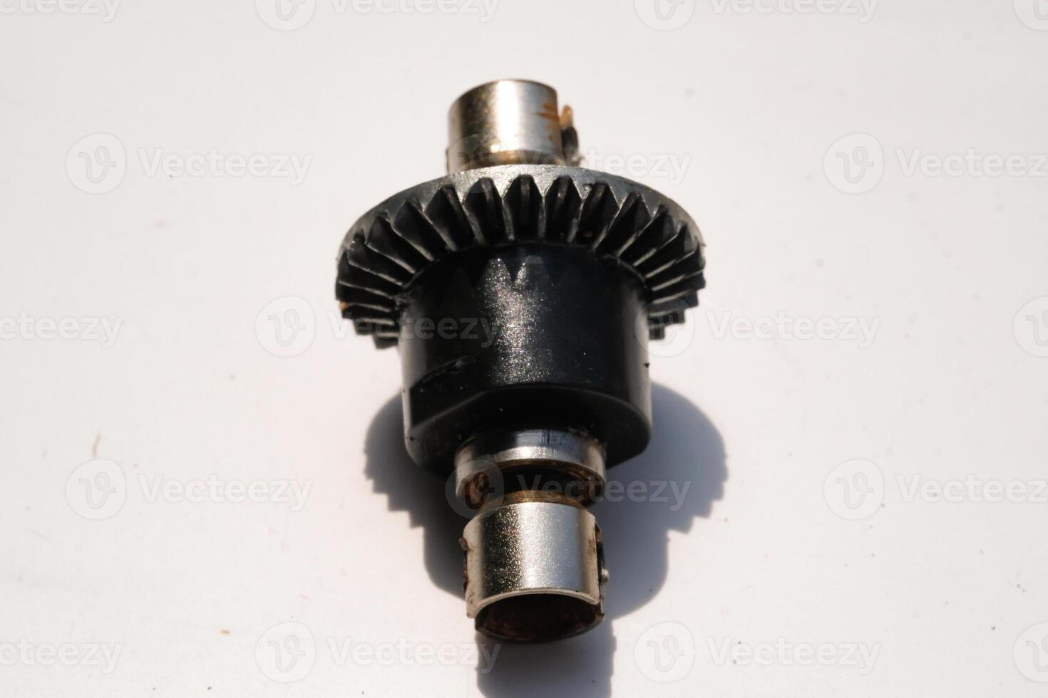 Closeup Remote Control Car Differential Gear isolated on white. Metal Gear parts allowing the wheels to turn at different speeds while receiving power from the motors. Toy Parts. Hobbies and leisures. photo