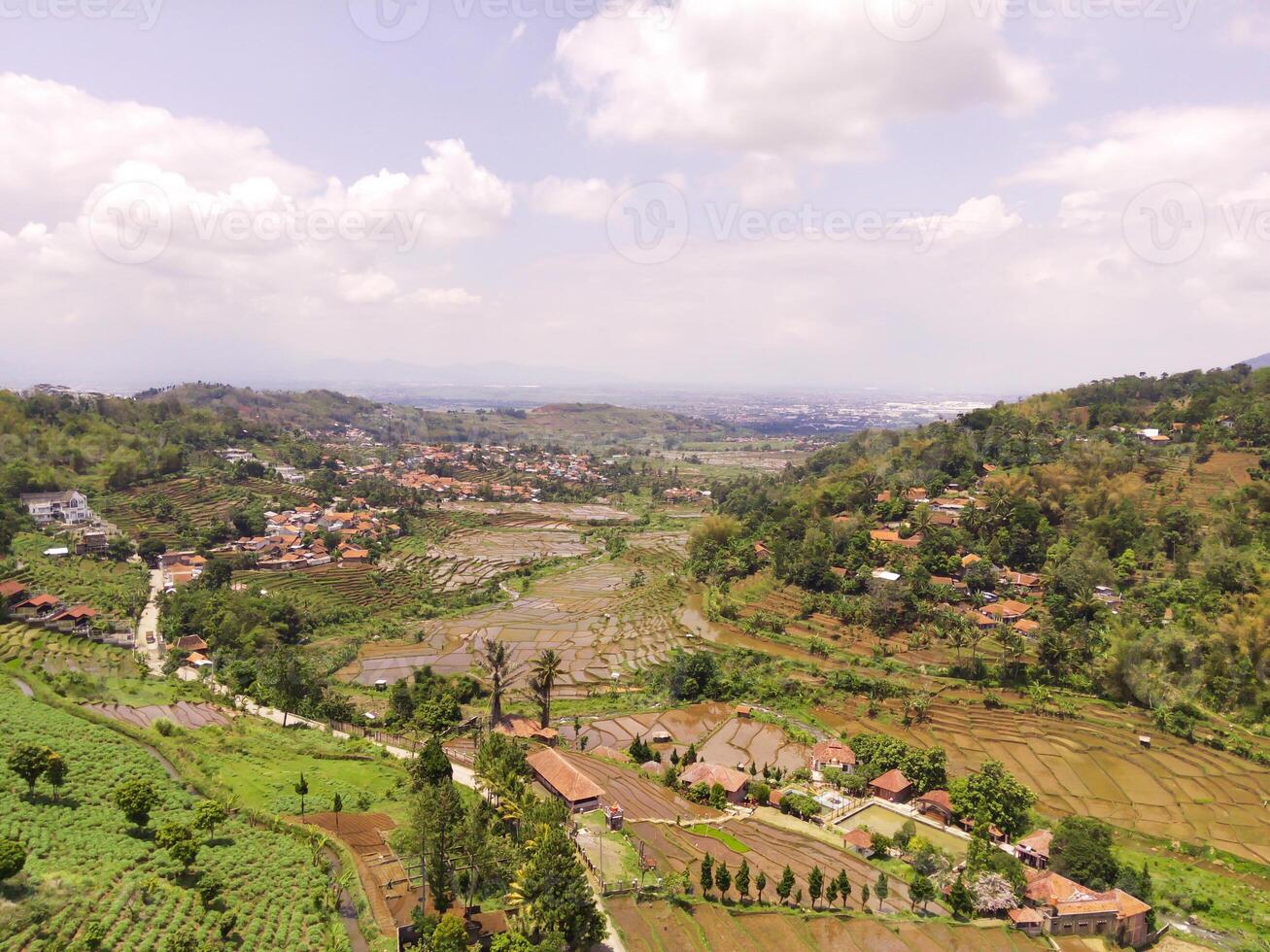 Majestic Ridge in the Cicalengka highlands, Indonesia. Gentle slopes with panoramic rice fields and villages along the valley. Countryside View. Drone Aerial. Landscape Photography photo
