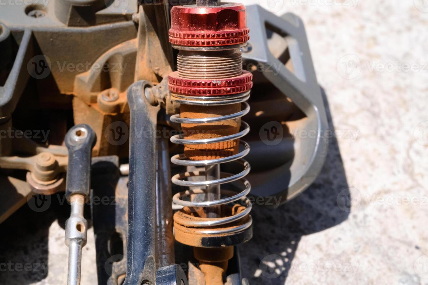 Remote Control Car Metal Oil Suspension in red color. Shock Absorber consisting of metal springs, tubes and lubricating oil. Metal Spare parts. Hobbies and Leisures photo