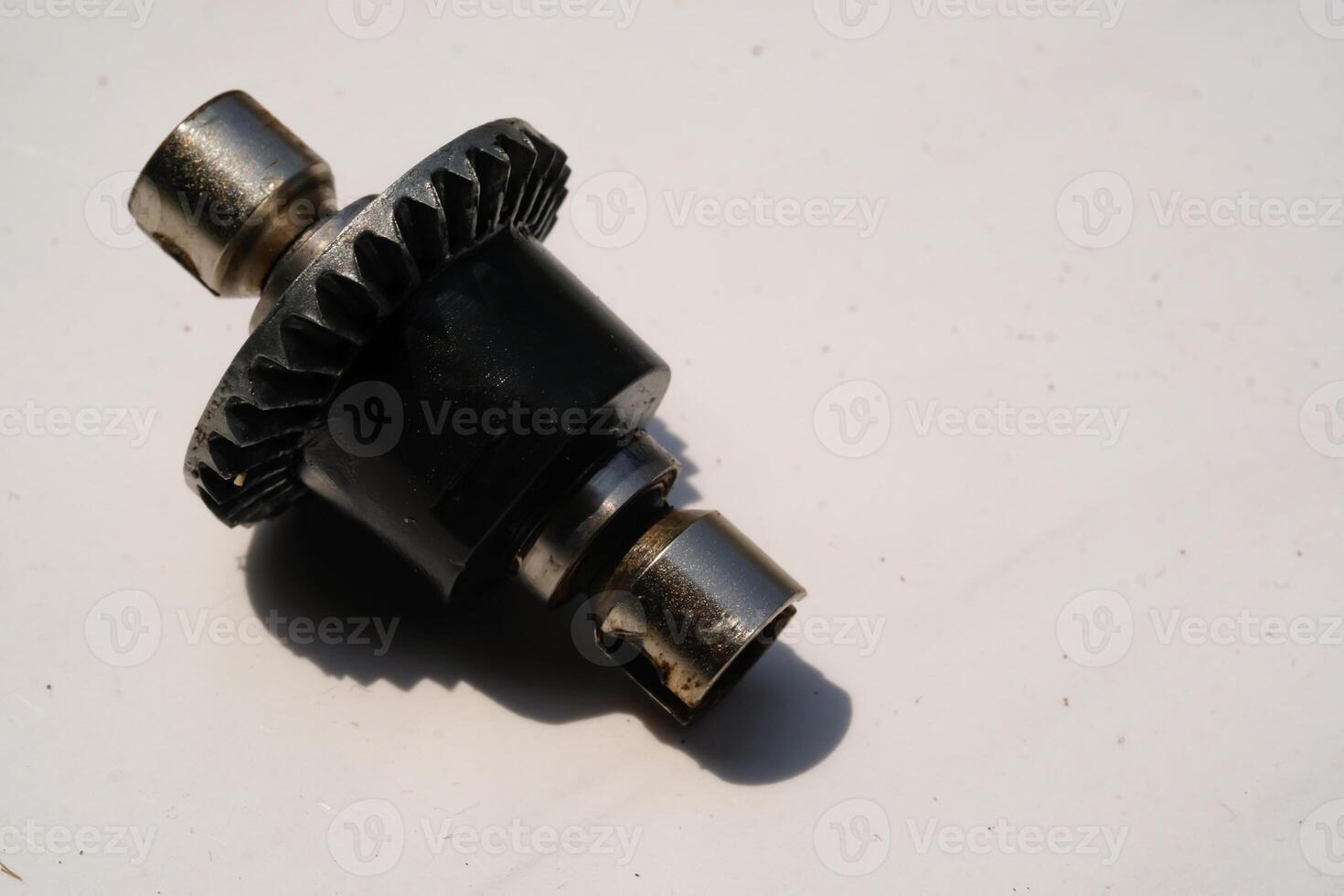 Closeup Remote Control Car Differential Gear isolated on white. Metal Gear parts allowing the wheels to turn at different speeds while receiving power from the motors. Toy Parts. Hobbies and leisures. photo
