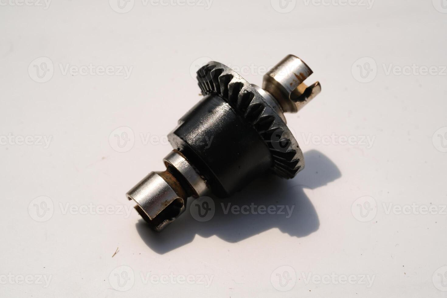 Closeup Remote Control Car Differential Gear isolated on white. Metal Gear parts allowing the wheels to turn at different speeds while receiving power from the motors. Toy Parts. Hobbies and leisures. photo