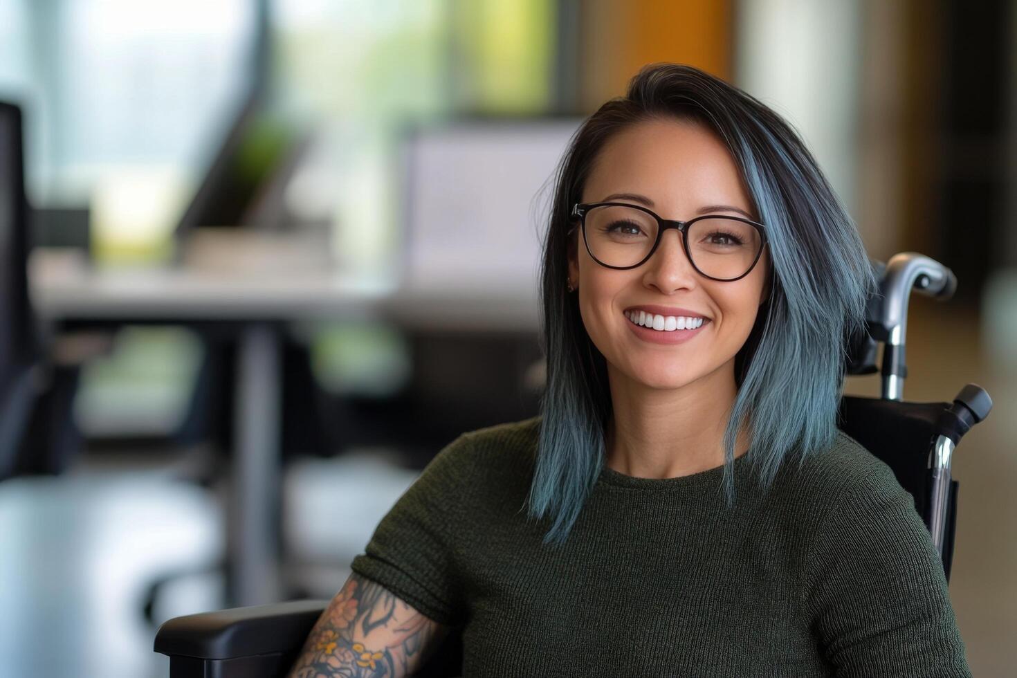 Young woman in wheelchair smiles while sitting in modern workspace with natural light photo