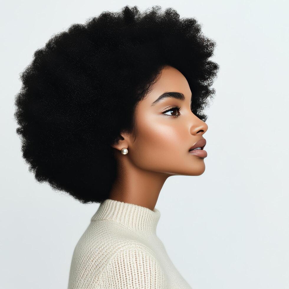 Profile of a young woman with natural curls, captured in soft light, showcasing elegance and beauty photo