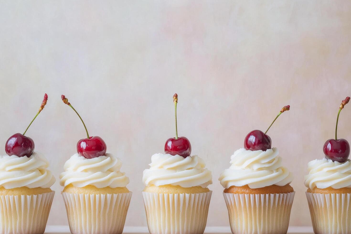 Delicious cupcakes topped with cherries arranged in a row on white background photo