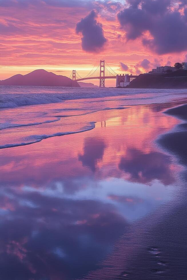 Stunning sunset over the golden gate bridge reflecting in the ocean photo