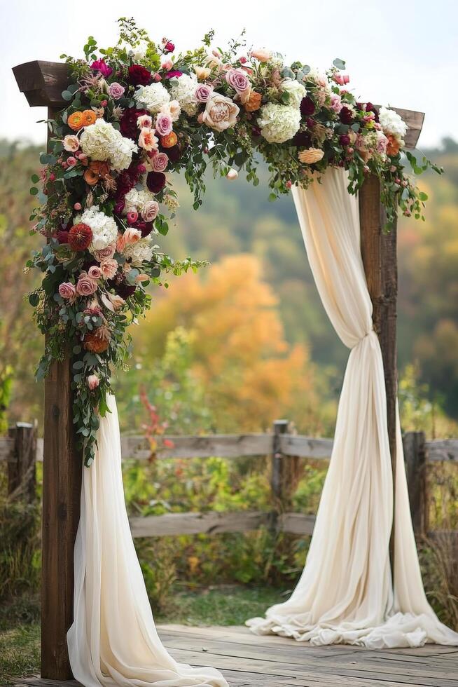 Beautiful floral arch adorned with colorful roses and draped fabric in an outdoor setting photo