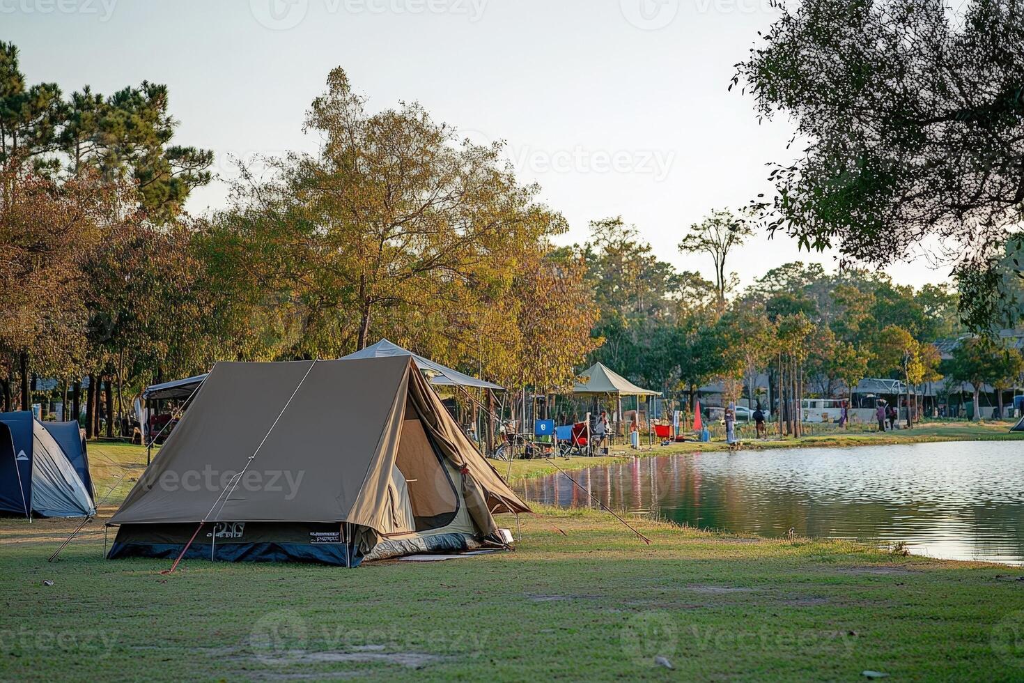 A tent is set up near a lake photo