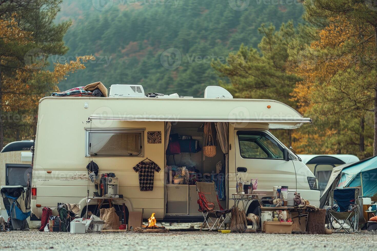 A camper van is parked in the middle of a forest photo