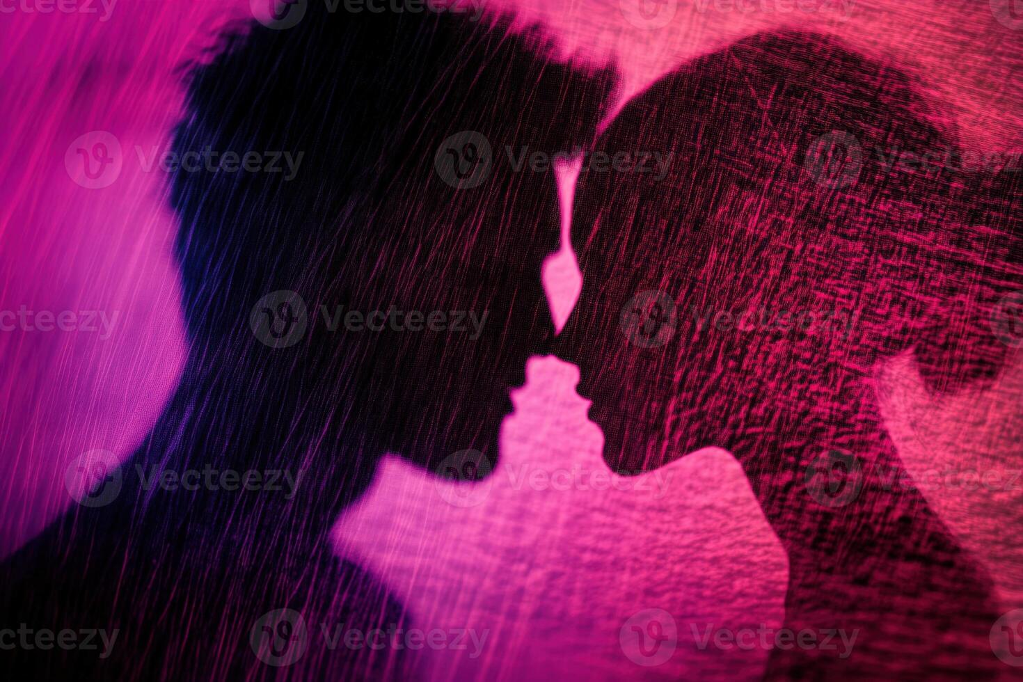A silhouette of a man and woman kissing in the rain photo