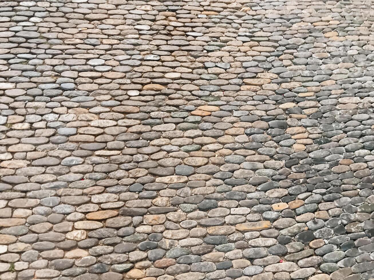 A stone wall with a pattern of small stones photo