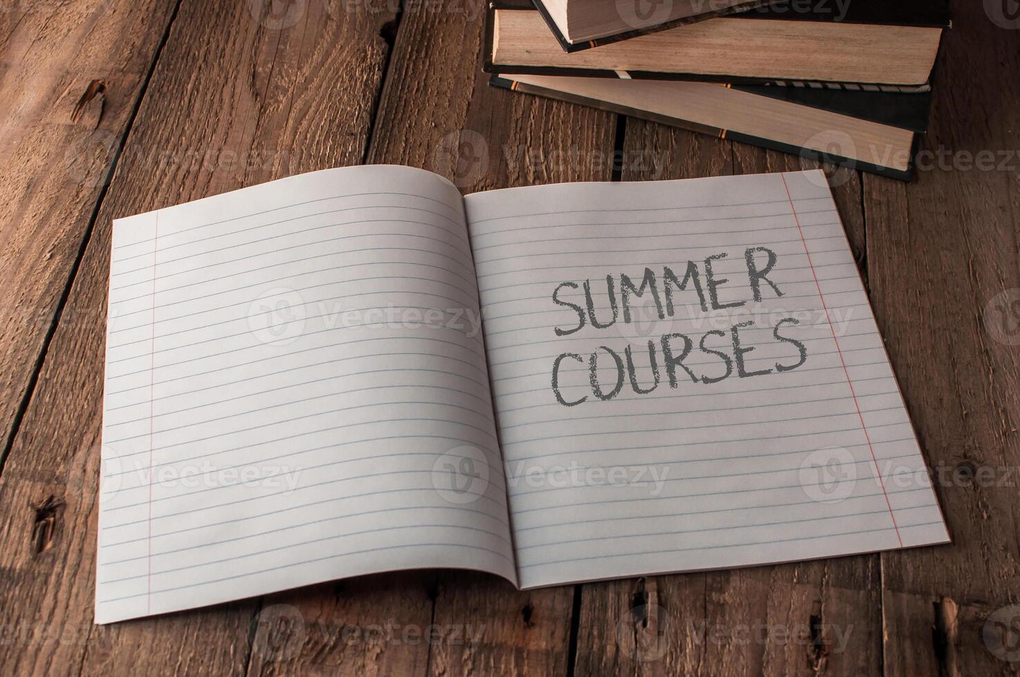 A notebook is open to a page with the words Summer Courses written on it photo