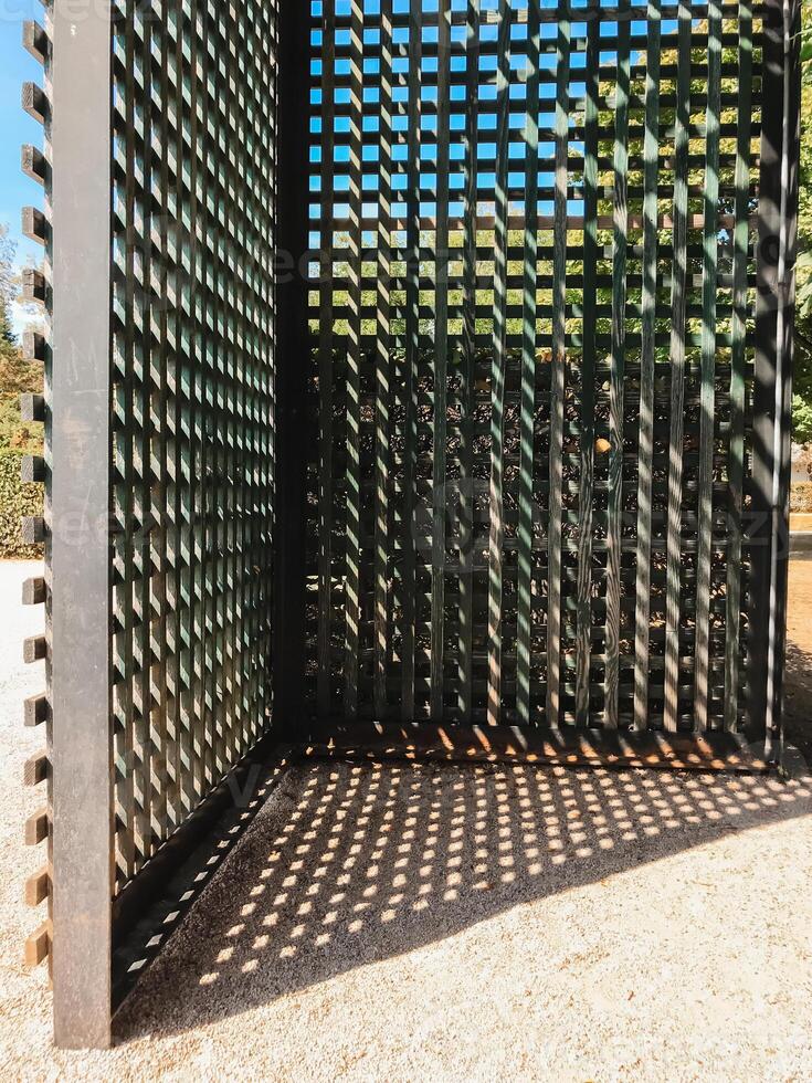 A black metal fence with a lattice design photo