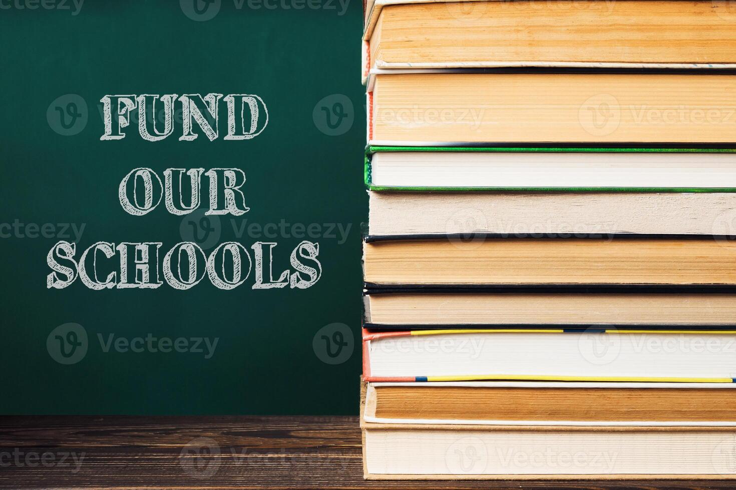 A stack of books with the words fund Our Schools photo