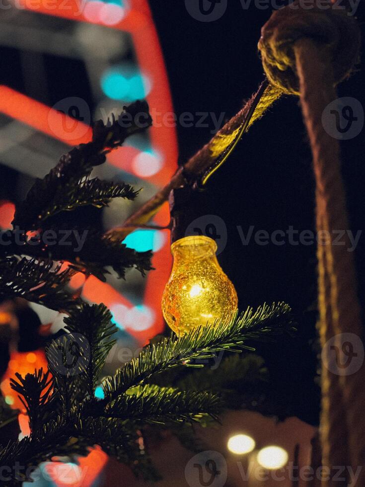 A Christmas tree adorned with yellow string lights. photo