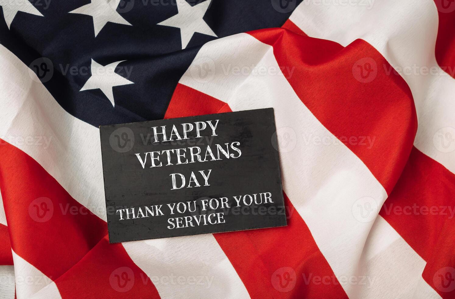 Black sign with the words Happy Veterans Day photo