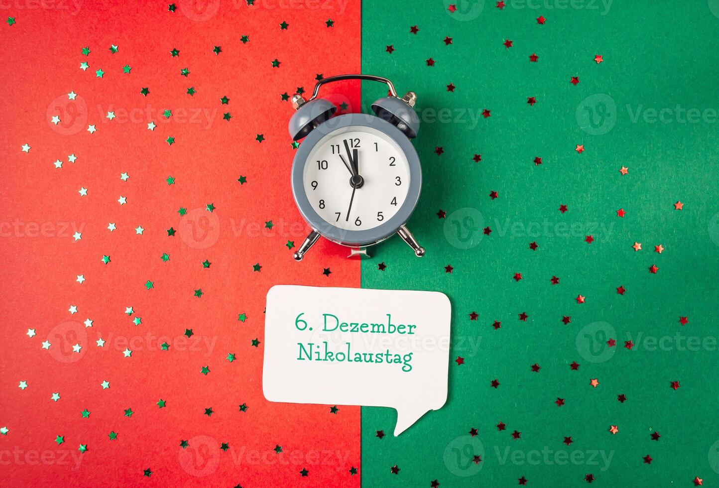 Festive clock with motivational message on red and green backdrop photo