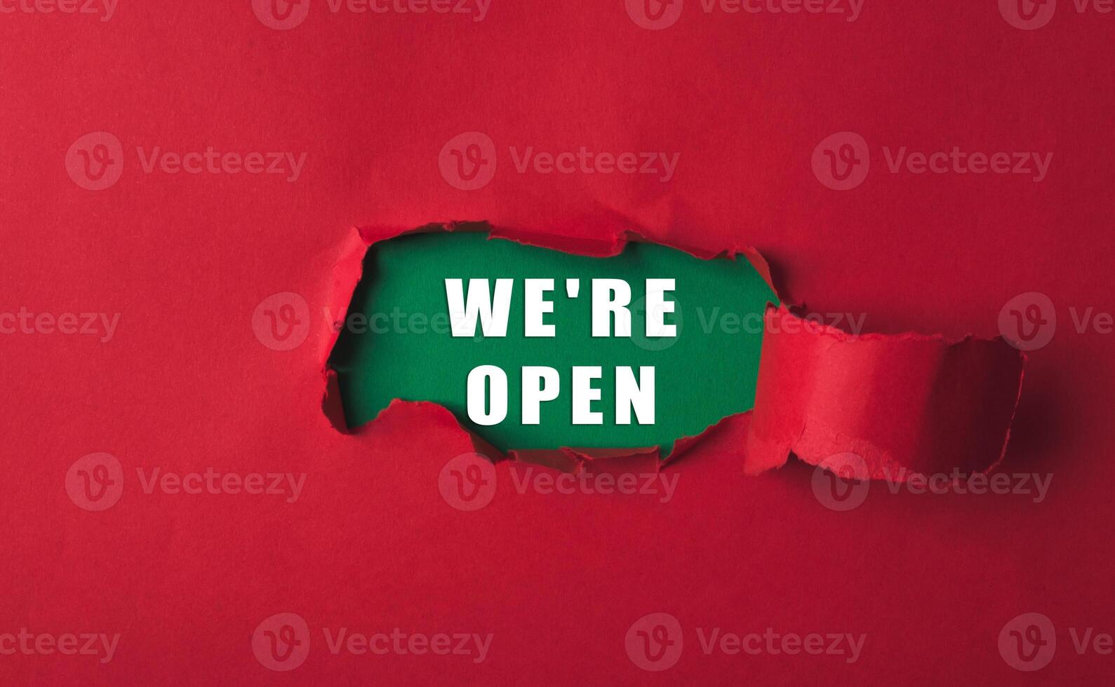 Red background with a green word that says we're open in white photo