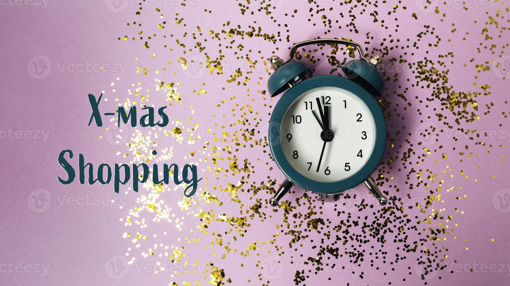 The clock is surrounded by glitter and the words Xmas Shopping photo