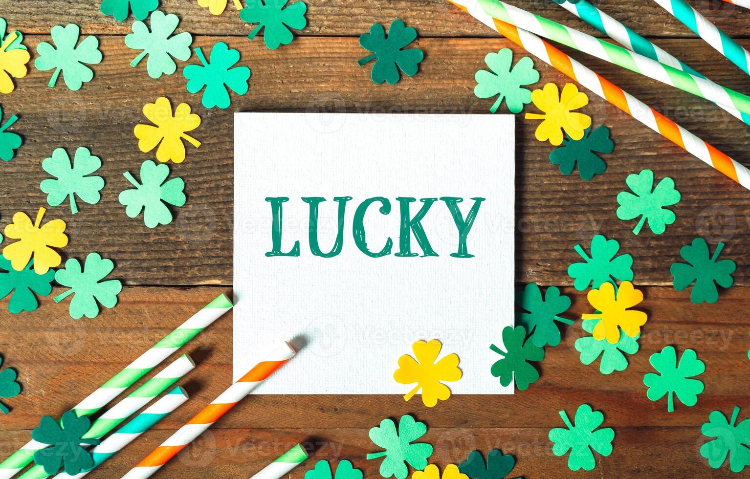 White sign with the word lucky written on it is surrounded by green photo