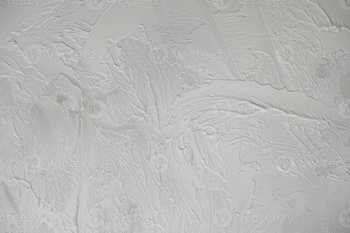Applying decorative putty. White abstract texture of surface covered with putty photo