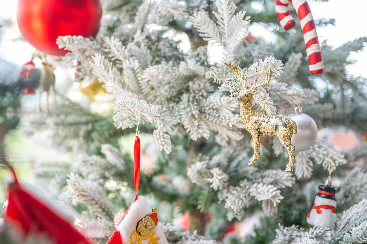 Christmas tree decorated with red and white stars and balls. Selective focus photo
