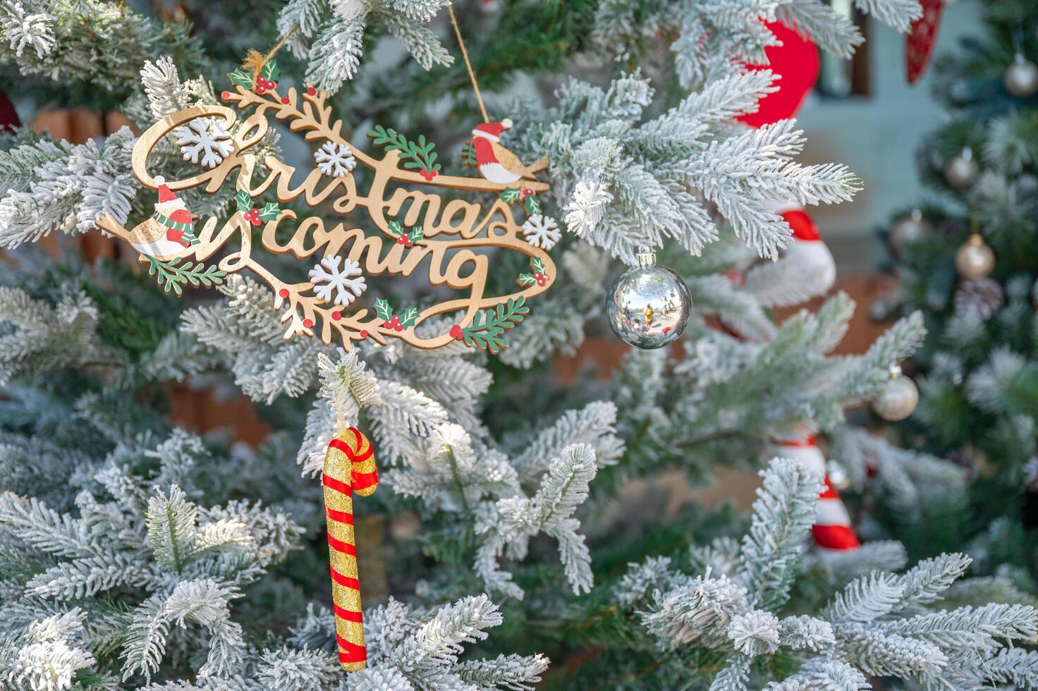 Christmas tree decorated with red and white stars and balls. Selective focus photo