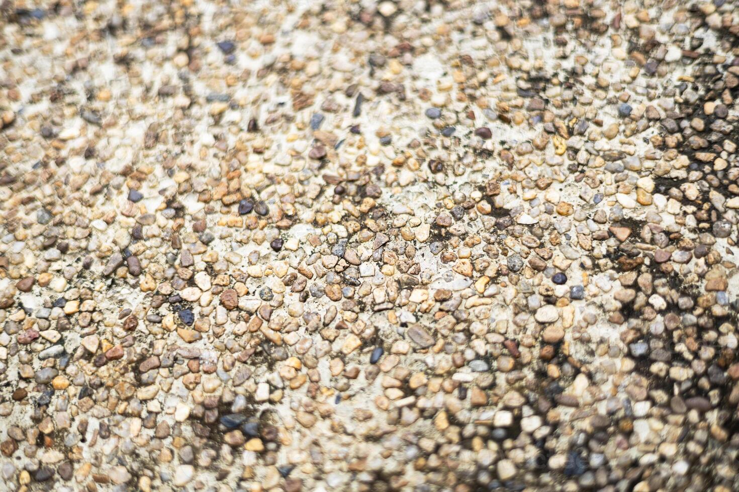Wall Of Exposed Concrete With Small Rocks photo