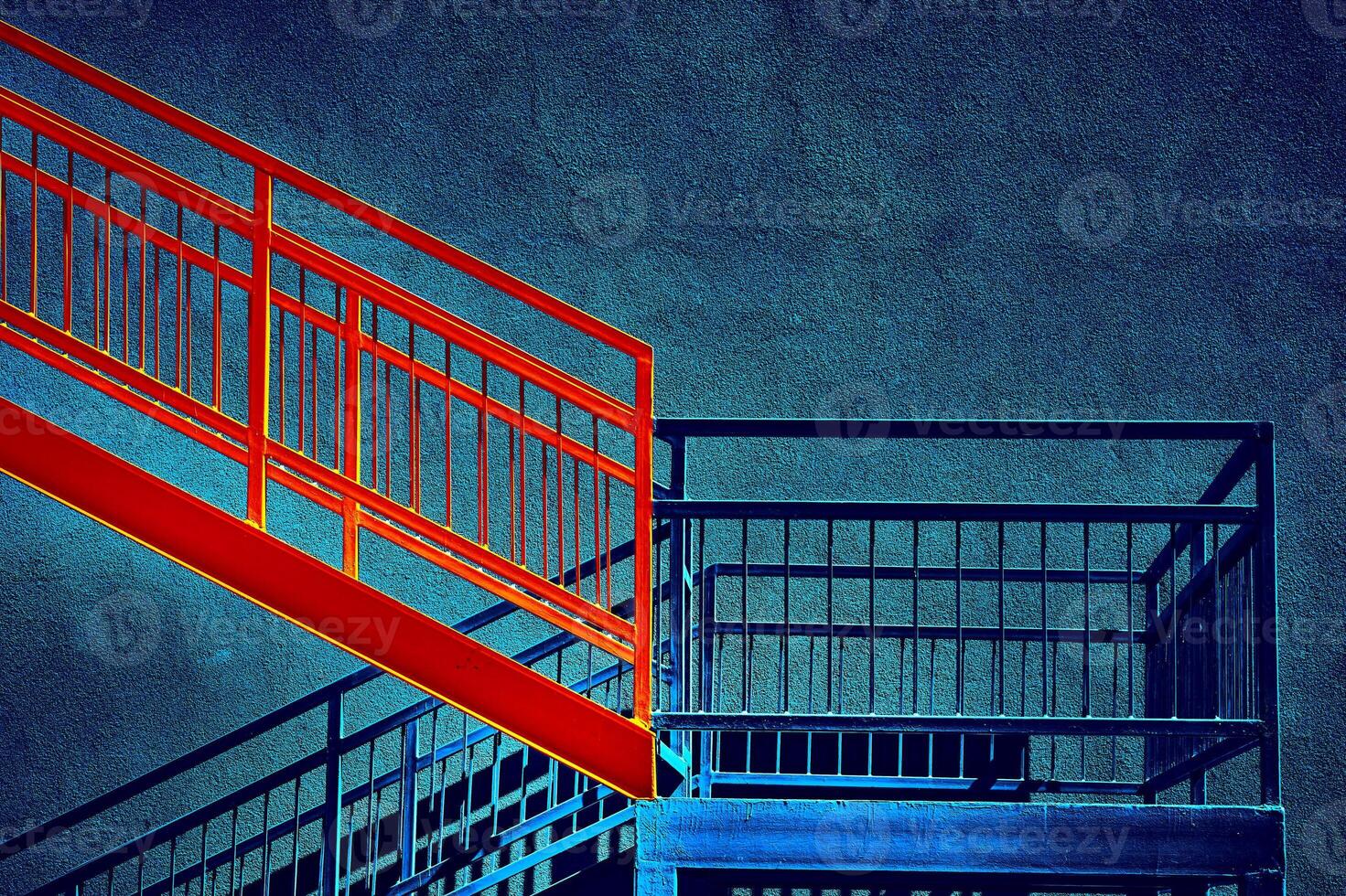 Red blue metallic staircase on emerald wall up down going photo