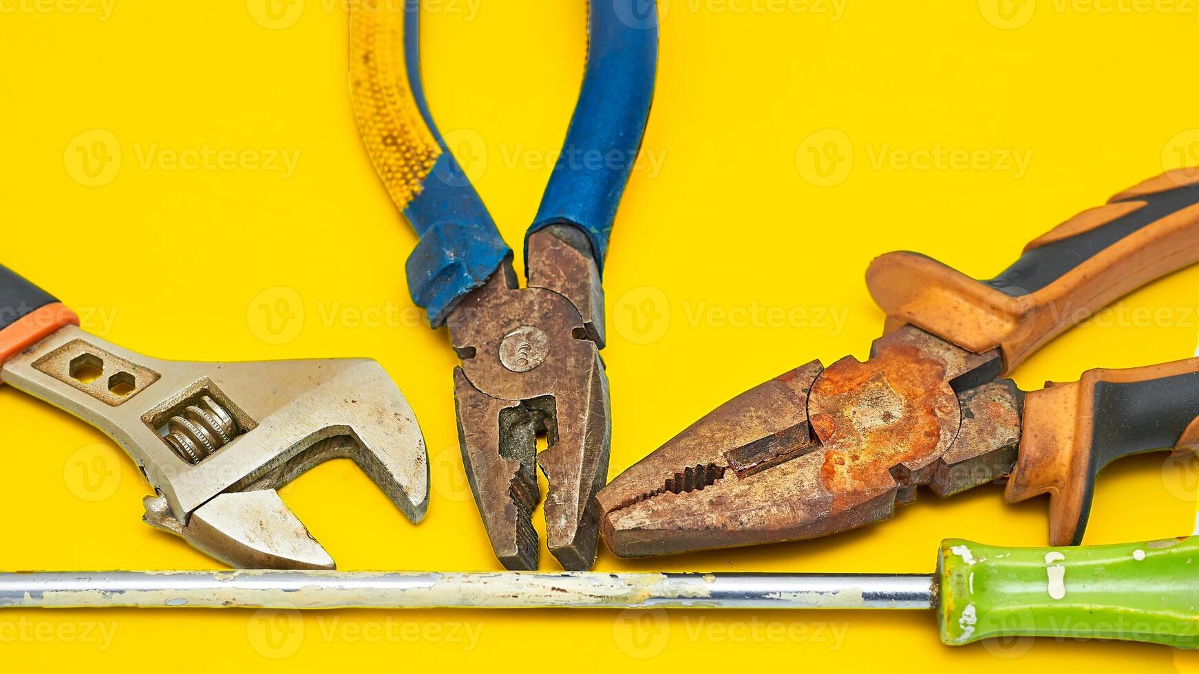 Old rusty pliers,screwdriver,adjustable wrench from the home shed for repair photo