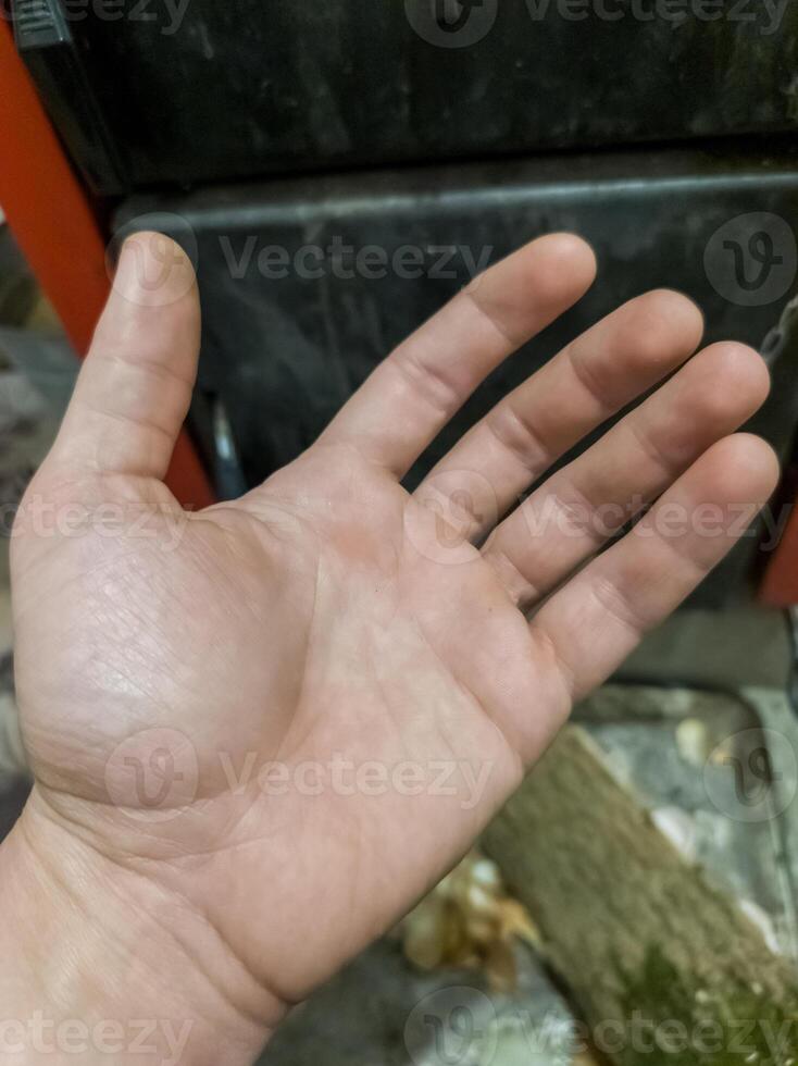 A person's hand is shown with their palm up in the air photo