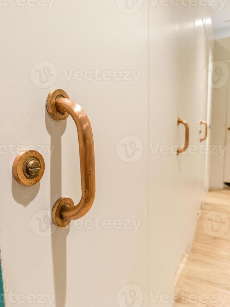 A close up of a door handle on a white door photo