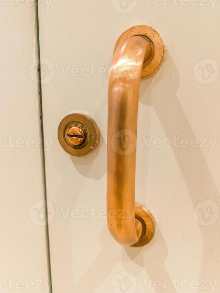 A close up of a door handle on a white door photo