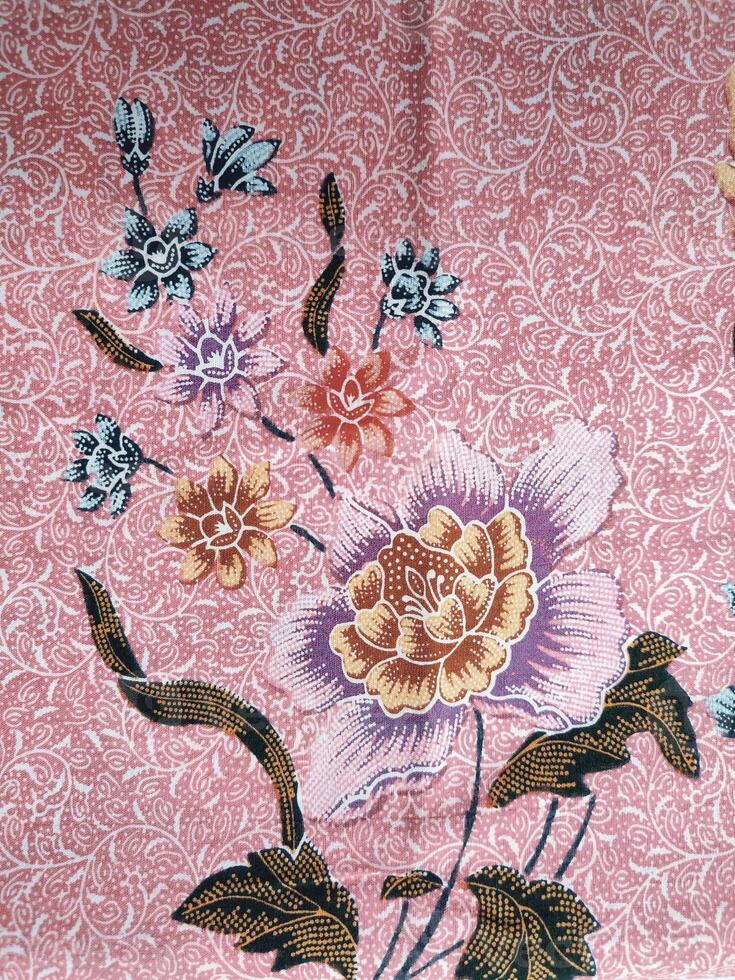 Indonesian batik patterns and backgrounds with images of flowers and leaves in many colors photo