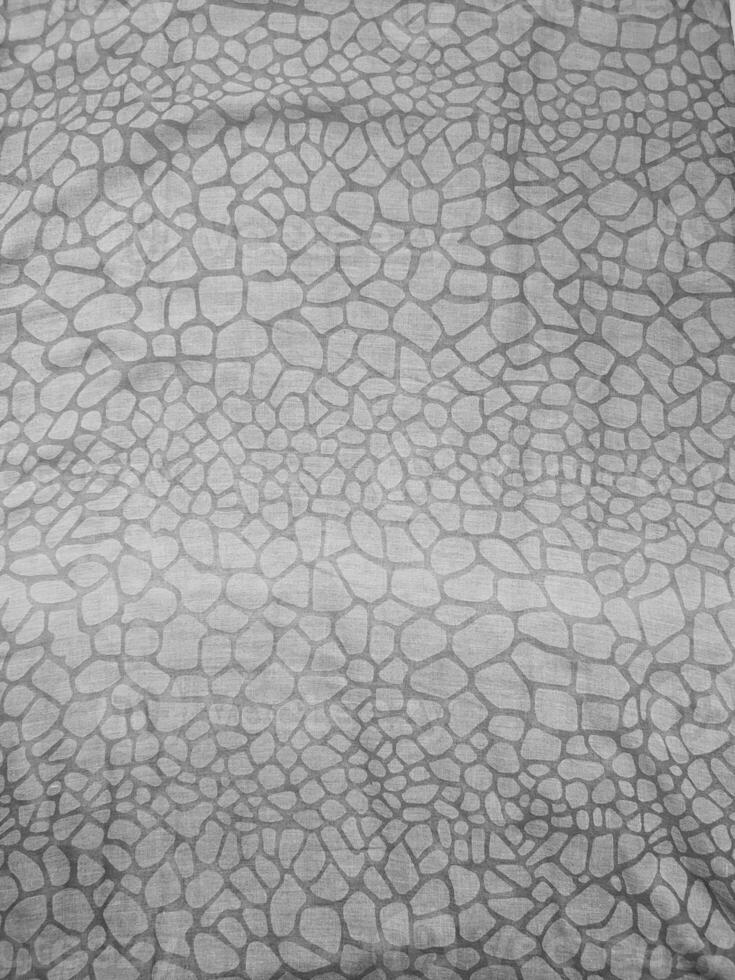 The texture, pattern and background of the grey animal skin patterned fabric photo