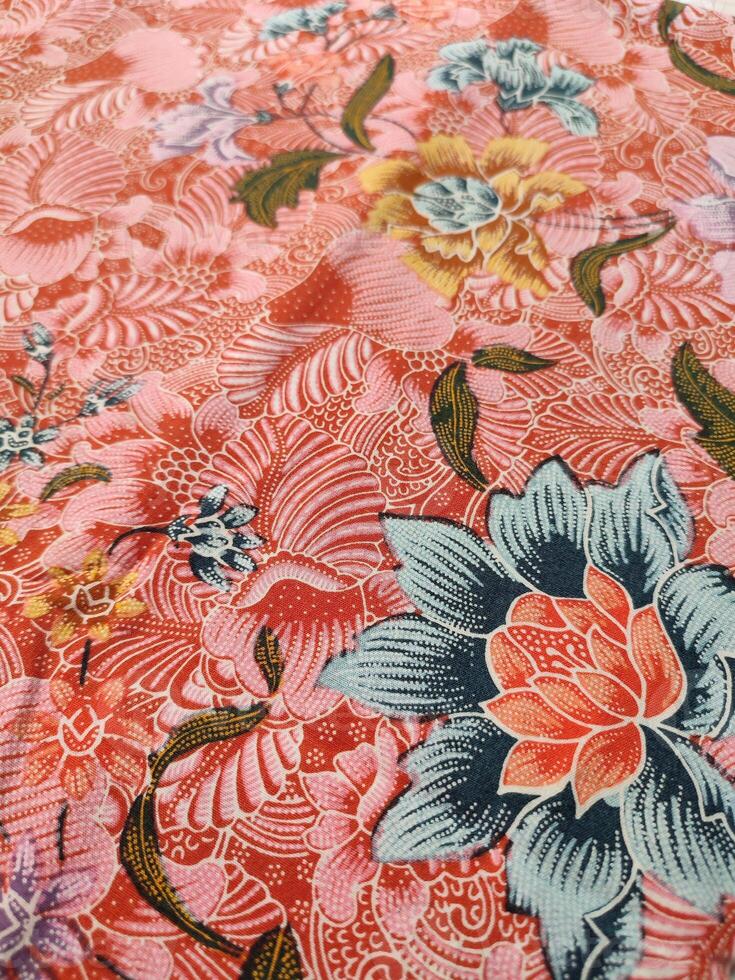 Indonesian batik patterns and backgrounds with images of flowers and leaves in many colors photo