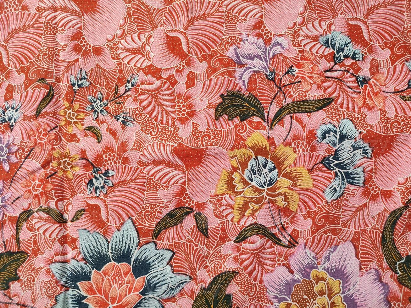 Indonesian batik patterns and backgrounds with images of flowers and leaves in many colors photo