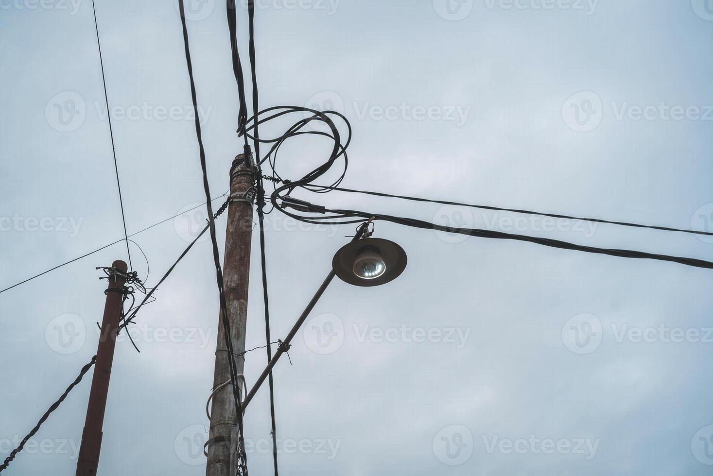 A street light is shown on top of a telephone pole photo