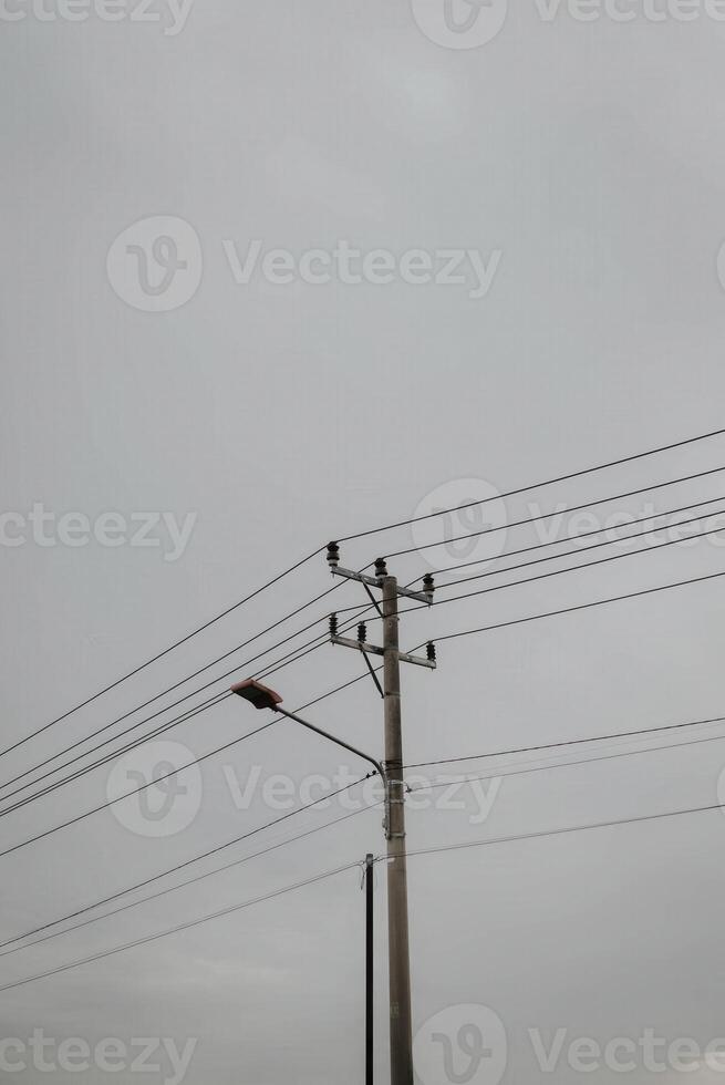 A street light is on top of a power pole photo