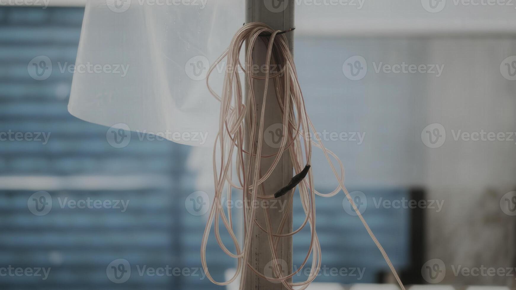 A white towel hanging from a pole photo