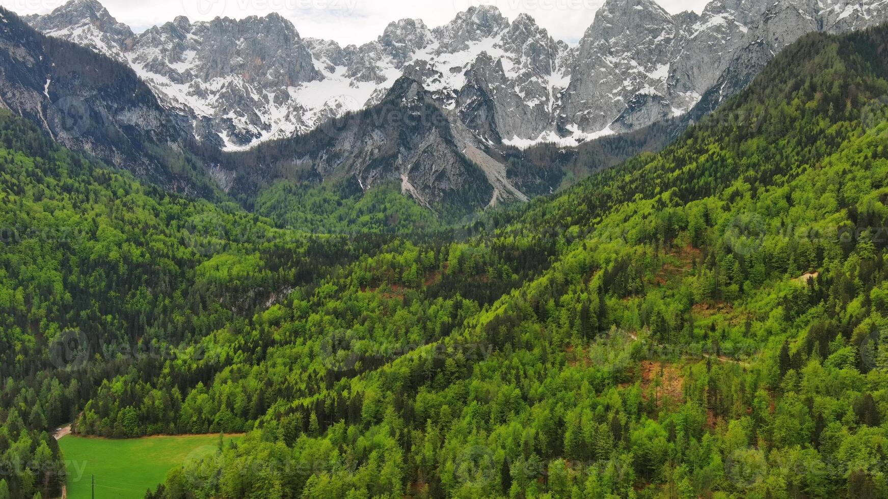 Green pasture and peaks of Apls mountain photo