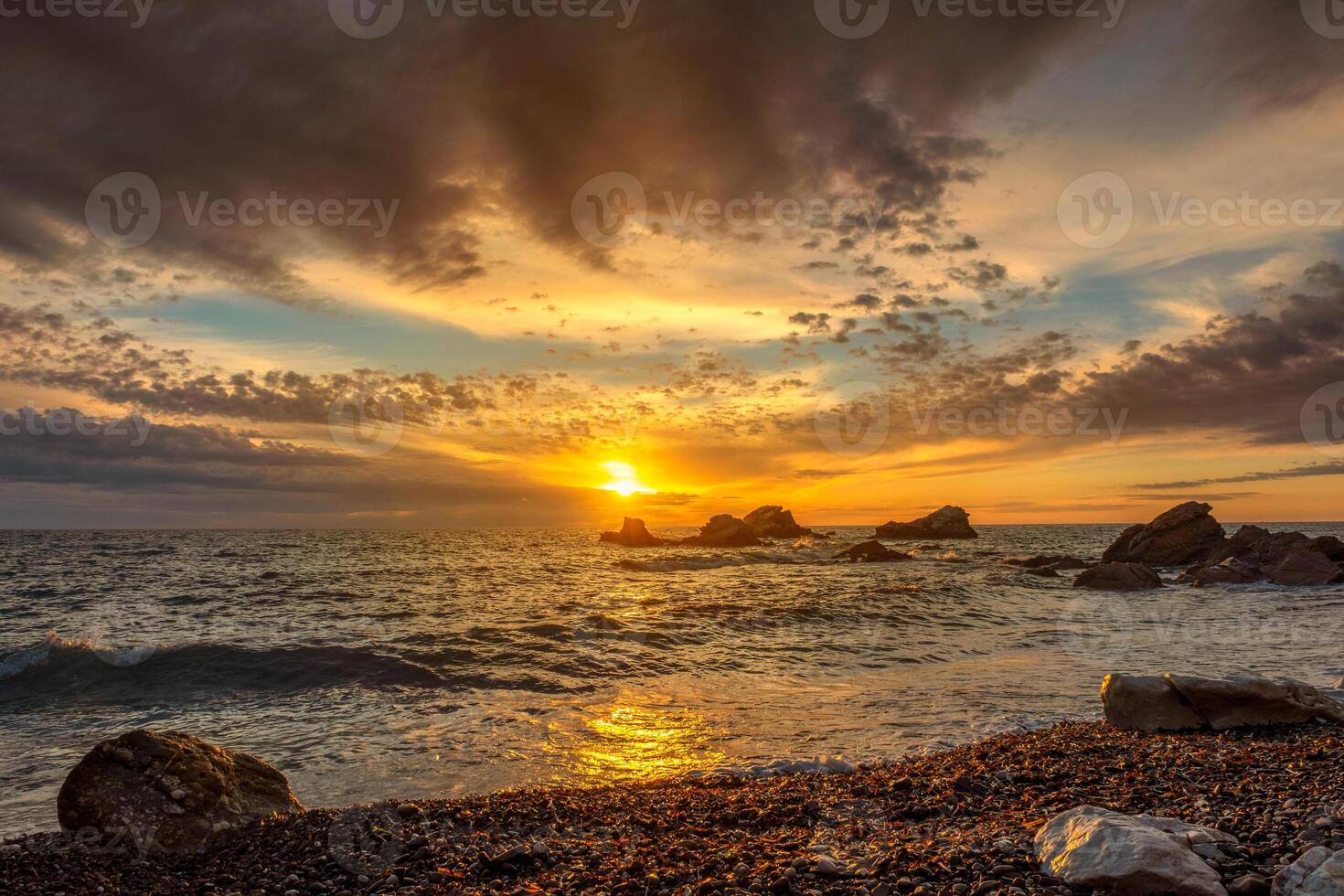Sunset sky over sea and rocks photo