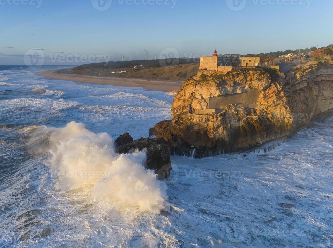 Lighthouse and big waves at in Nazare photo