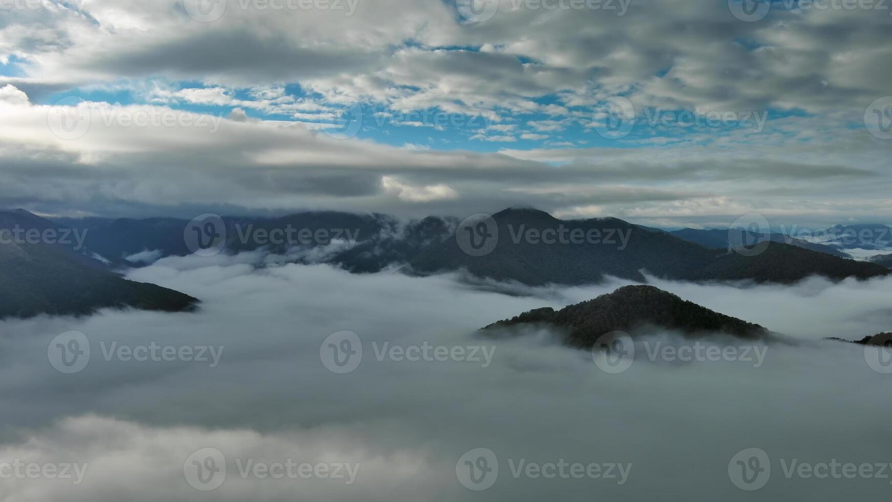 Aerial view of clouds and mountains at sunrise photo