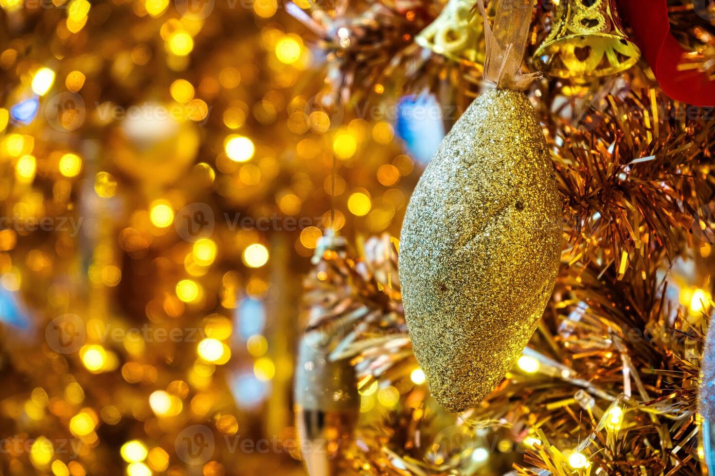 Luxurious Golden Christmas Tree Adorned with Sparkling Ornaments for the Holidays photo