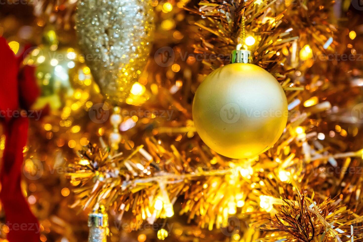 Luxurious Golden Christmas Tree Adorned with Sparkling Ornaments for the Holidays photo