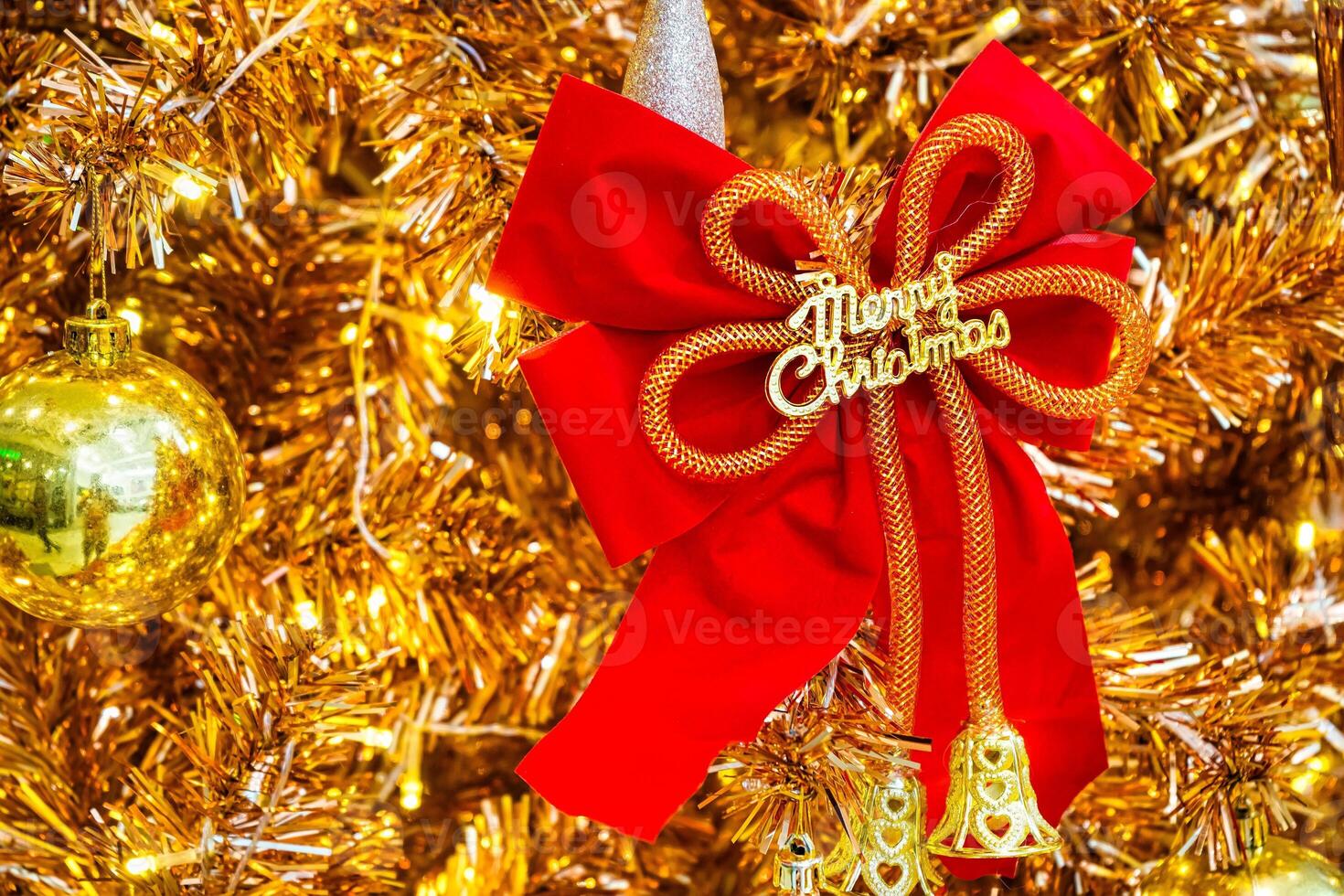 Luxurious Golden Christmas Tree Adorned with Sparkling Ornaments for the Holidays photo