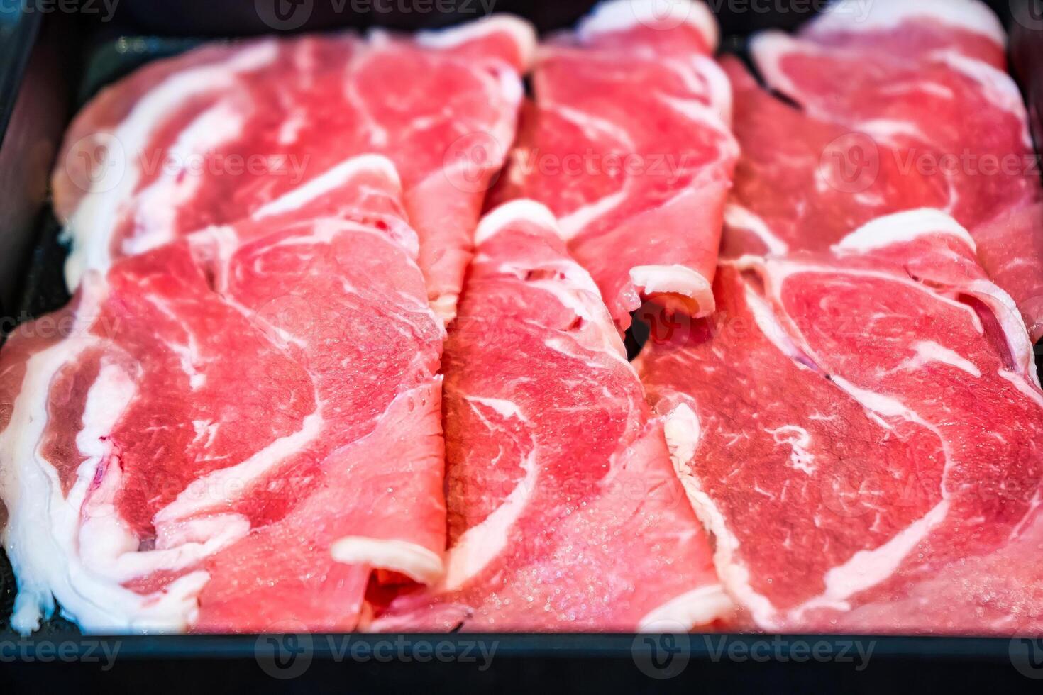 Tender and Juicy Beef Slices Featuring Intricate Marbling, Ready for Hotpot, Grilling, or Stir-Fry photo