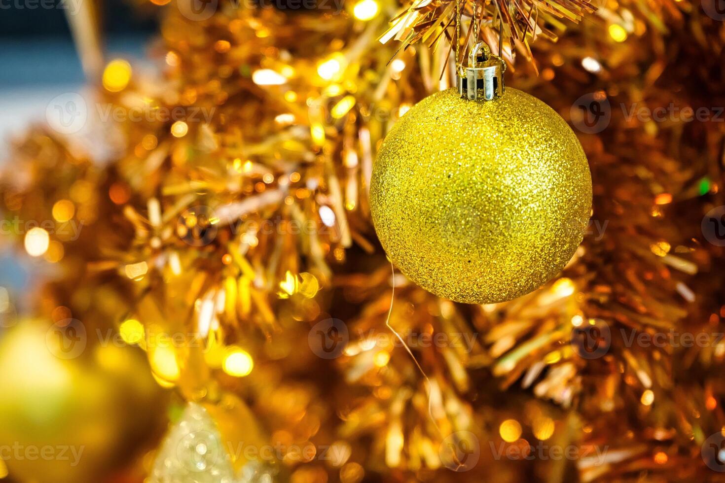 Luxurious Golden Christmas Tree Adorned with Sparkling Ornaments for the Holidays photo