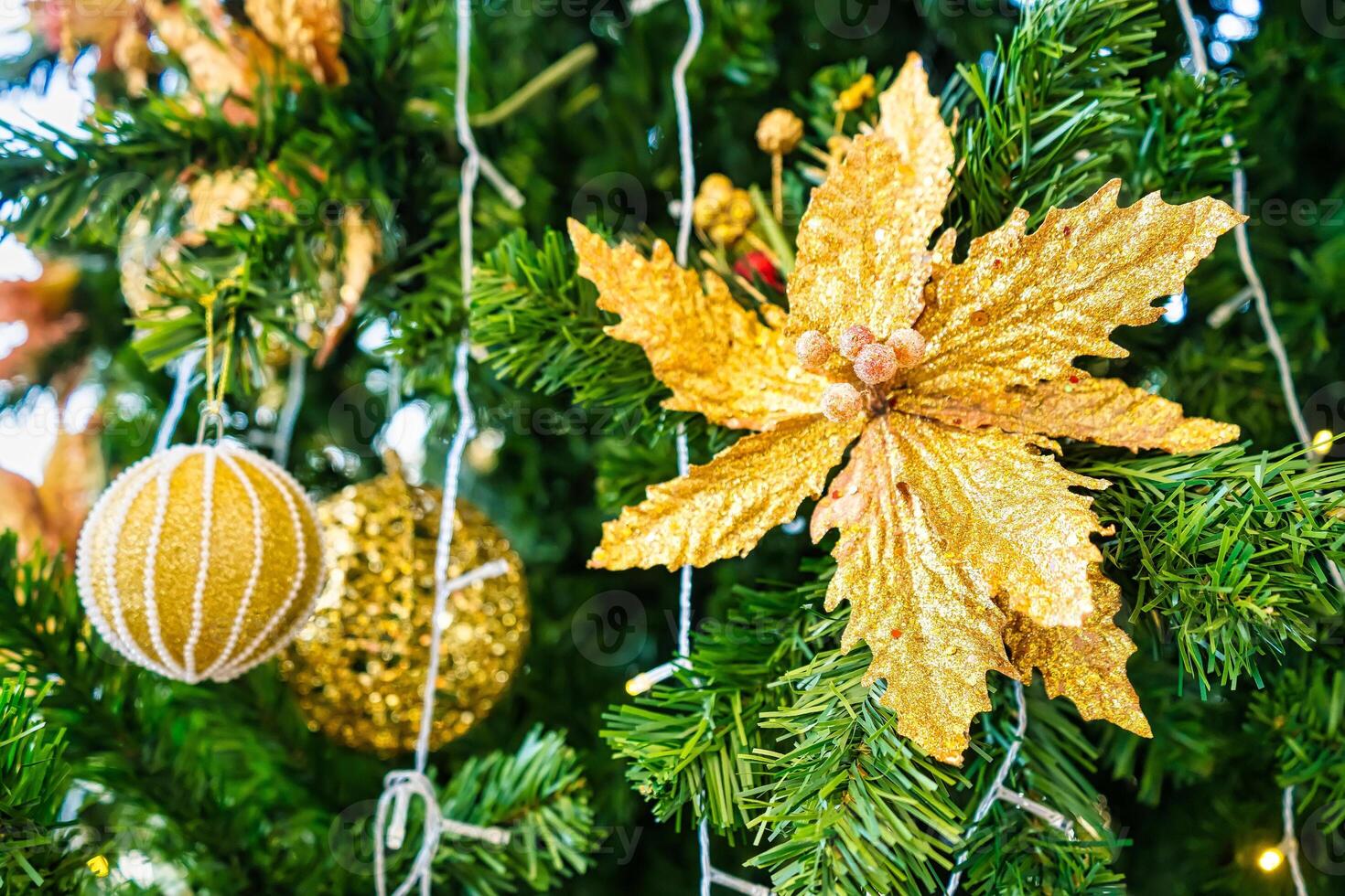 Luxurious Golden Christmas Tree Adorned with Sparkling Ornaments for the Holidays photo