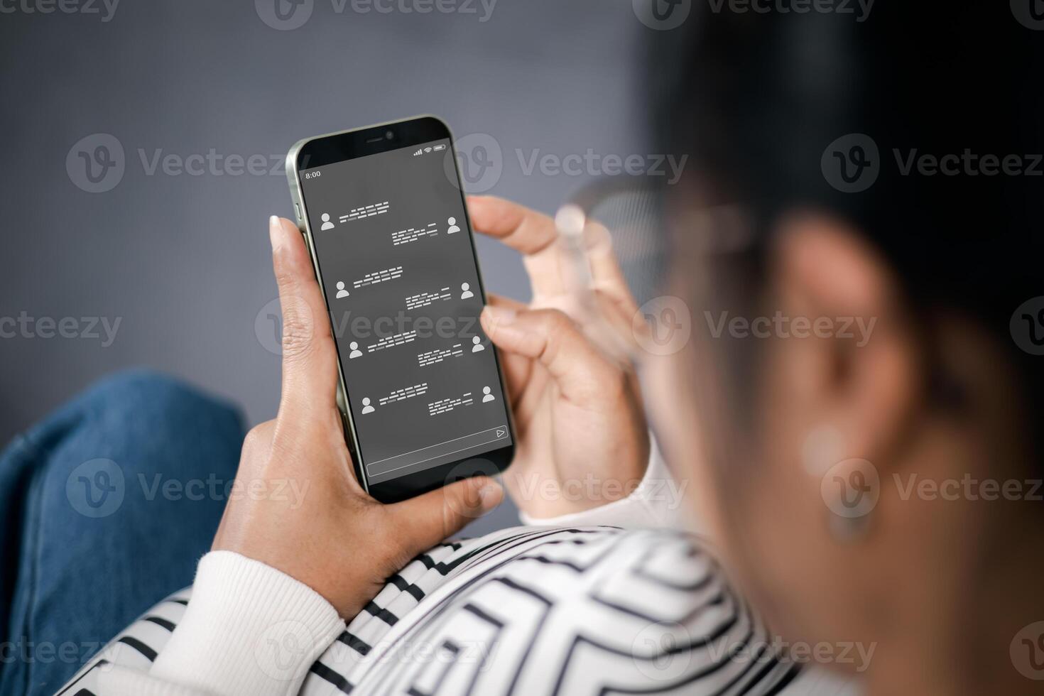 Wireless communications and social concept. Woman with smartphone with instant messaging on the screen. All screen graphics made up. Woman using instant messaging app on mobile phone. photo